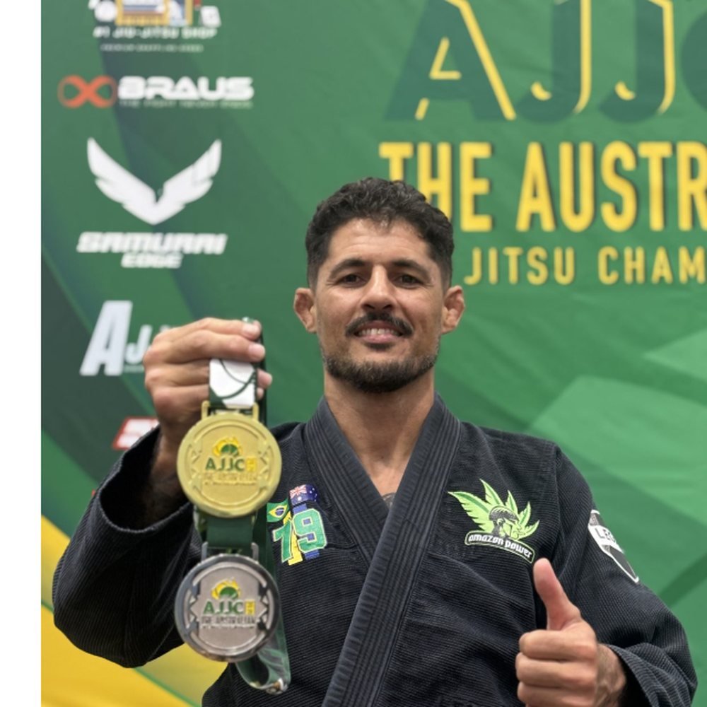 Professor Lucas holding his gold and silver medals at AJJC 2026