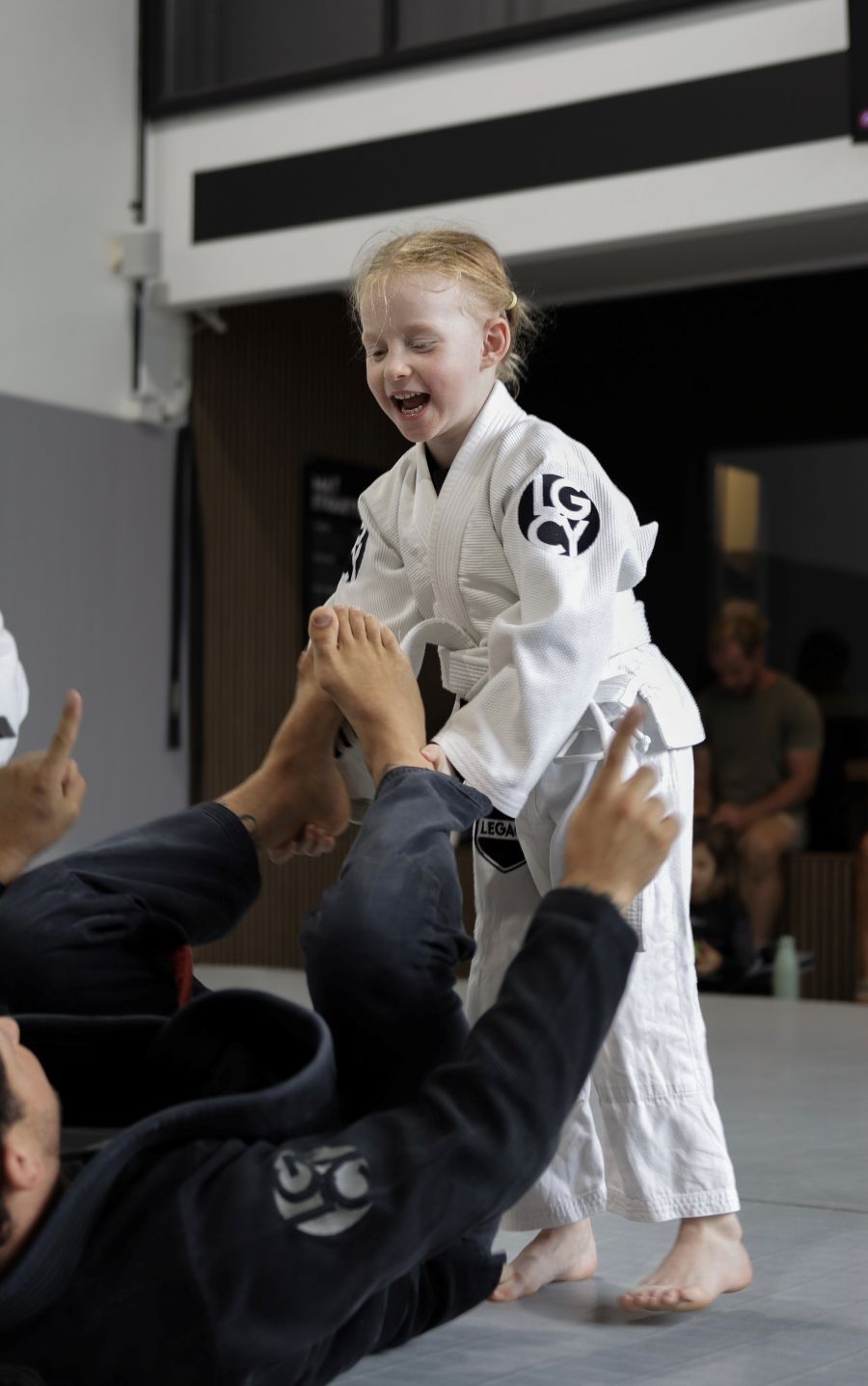 Coach and student high-fiving at Legacy Jiu Jitsu
