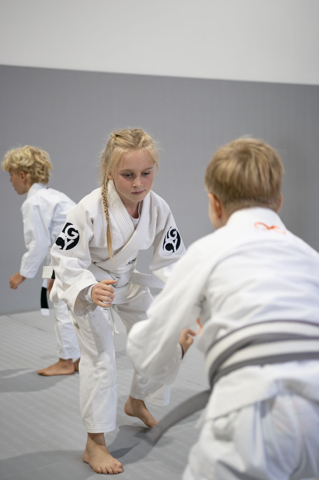 Kids training technique together on the mats