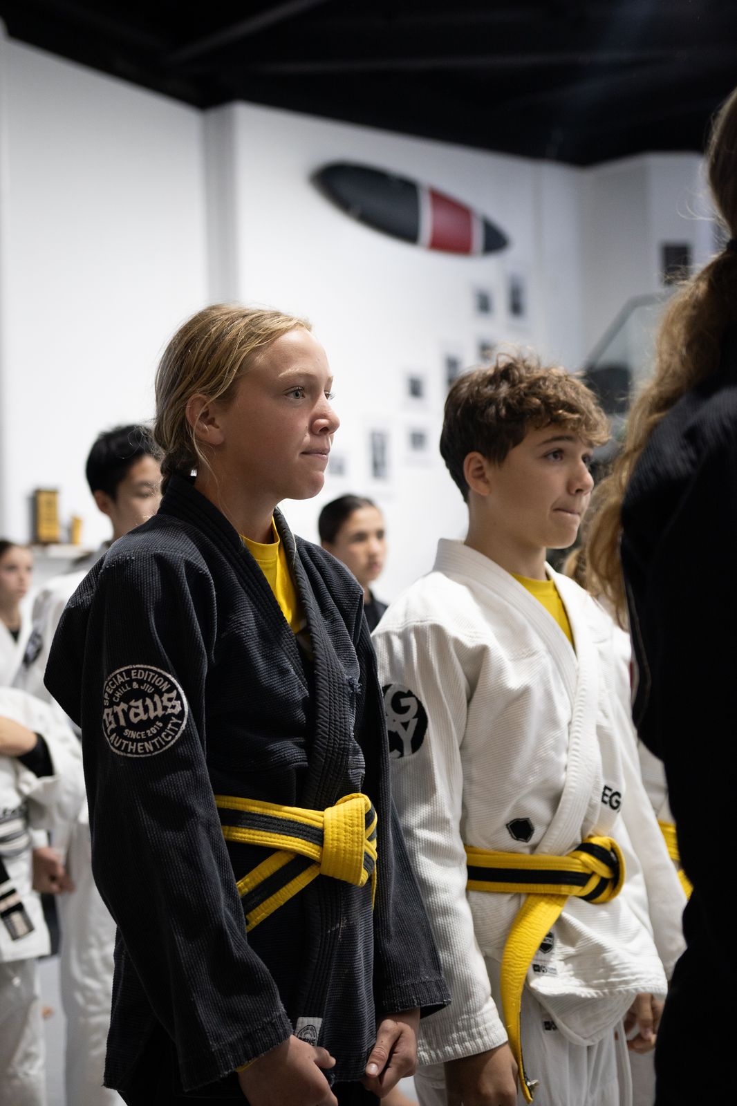 Teenage students standing together on the mats